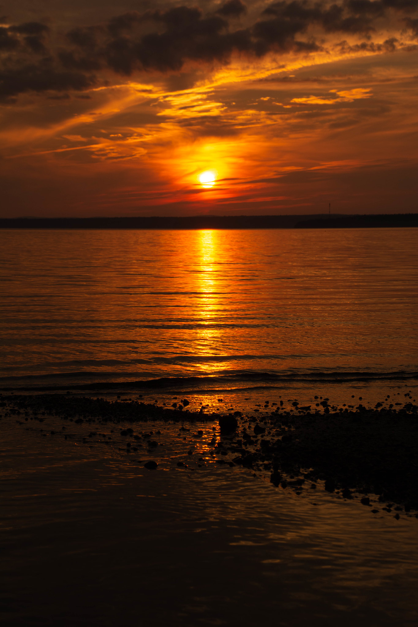 Orange sunset reflected across the cove.