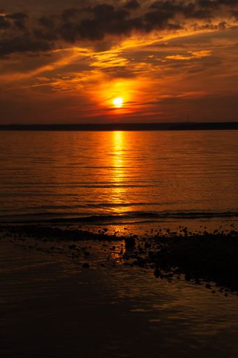 Orange sunset reflected across the cove.